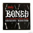 A hard black box displays bold white text "Bones Hardcore Bushing Hard Black" and red "High Performance Double Action," with a grunge design of repeated vertical reflections—ideal for showcasing these skateboard bushings.