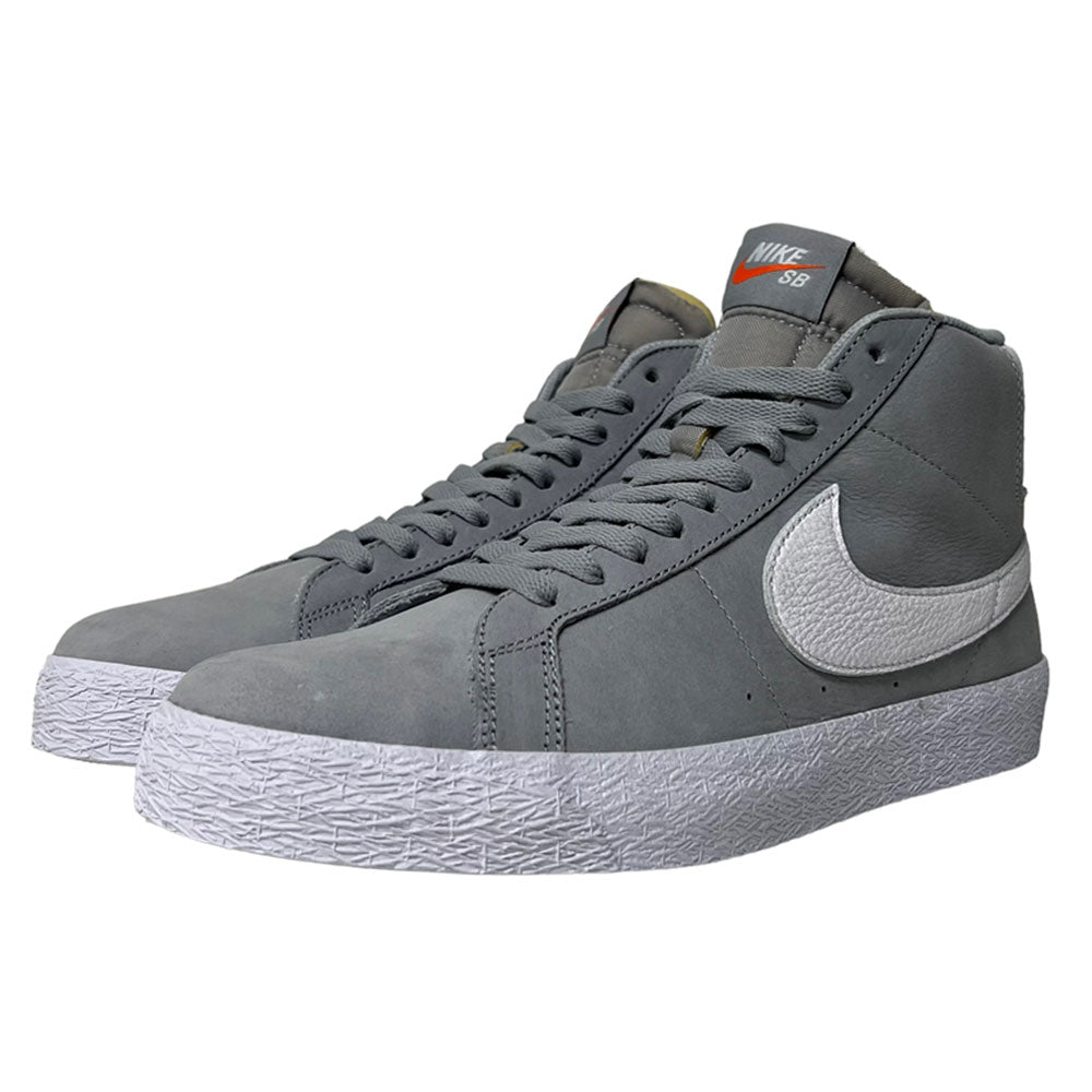 The Nike SB Blazer Mid DV5467001 White Wolf Grey Shoes feature a gray high-top design, white textured soles, white side swooshes, gray laces, and a tongue with an orange and white Nike SB label for classic skate style.
