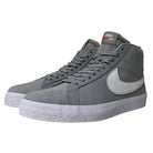 The Nike SB Blazer Mid DV5467001 White Wolf Grey Shoes feature a gray high-top design, white textured soles, white side swooshes, gray laces, and a tongue with an orange and white Nike SB label for classic skate style.