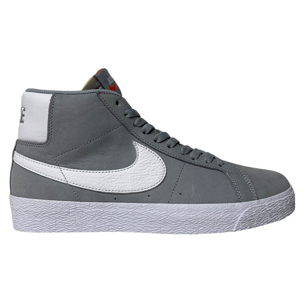 The Nike SB Blazer Mid DV5467001 White Wolf Grey Shoes are high-top sneakers featuring a large white Swoosh, grey upper, white heel detail, grey laces, and a textured white sole for skate style and responsive cushioning, shown in side profile.
