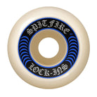 The Spitfire Wheels F4 Lock In 52mm99A is a white skateboard wheel with a black and blue circular design. "SPITFIRE LOCK-INS" appears in Gothic letters, and size/specs are marked on the outer ring for style and performance.