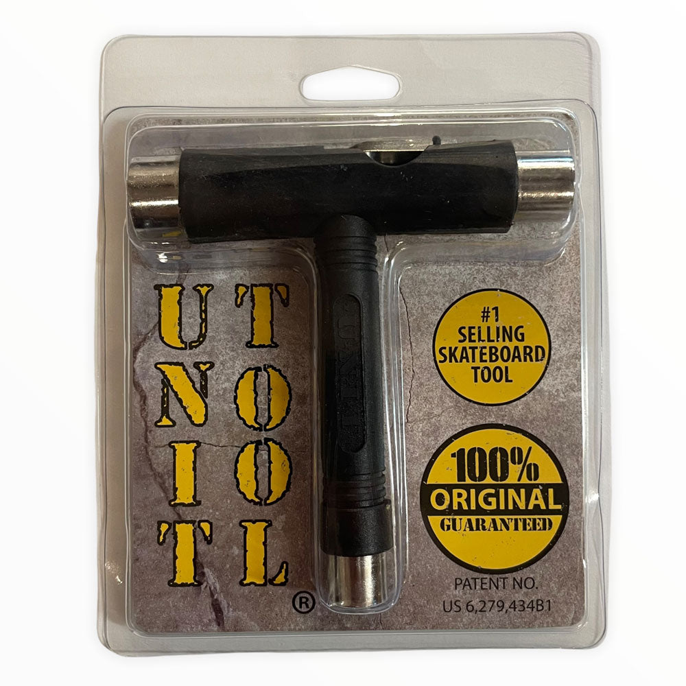 The Unit Skate Tool Black Chrome comes in clear plastic with a branded cardboard backing, featuring yellow circles that highlight “#1 Selling Skateboard Tool” and “100% Original Guaranteed.”.